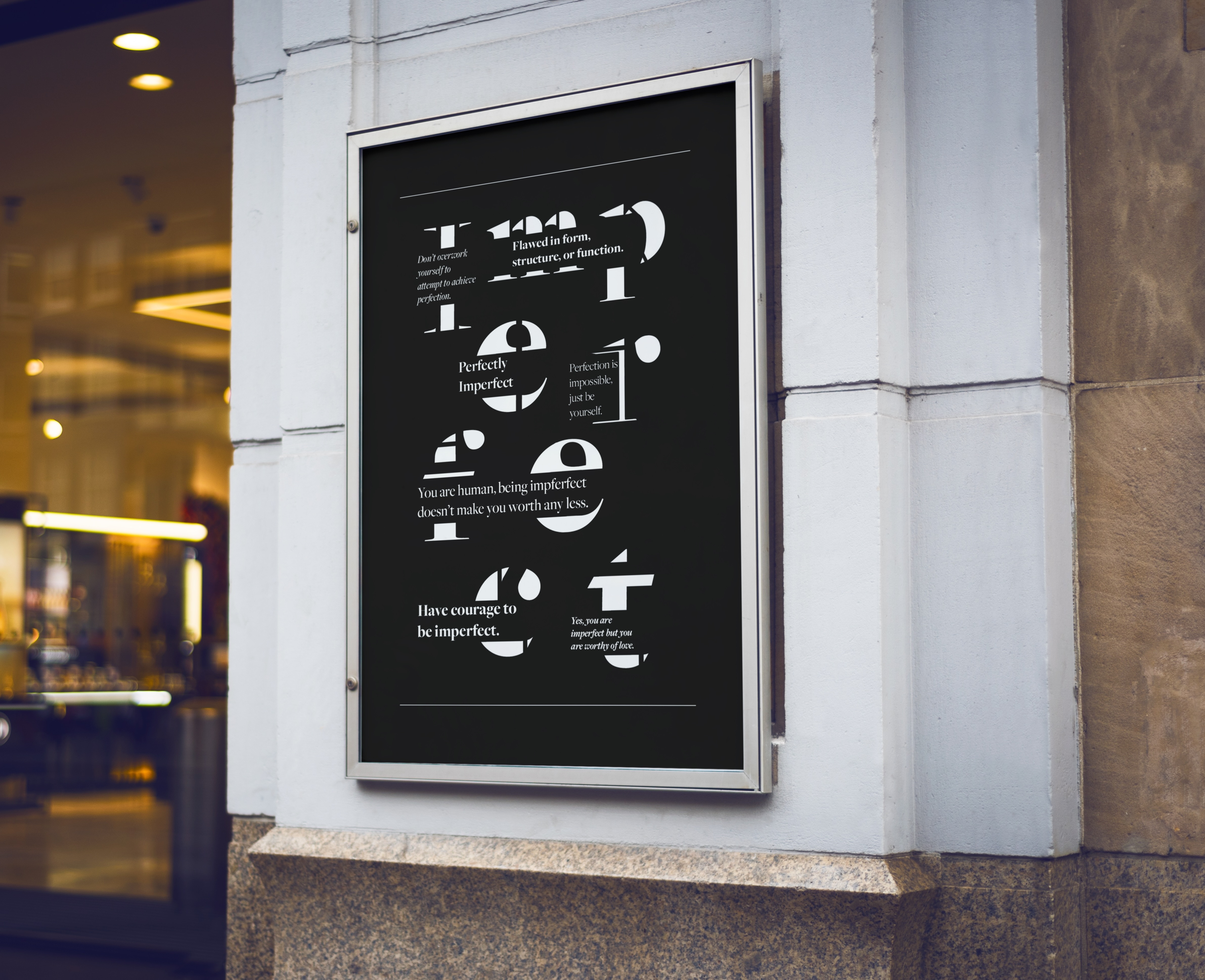 Close up of a mockup of two posters of expressive type, one in black, and one and inverted version of the first.