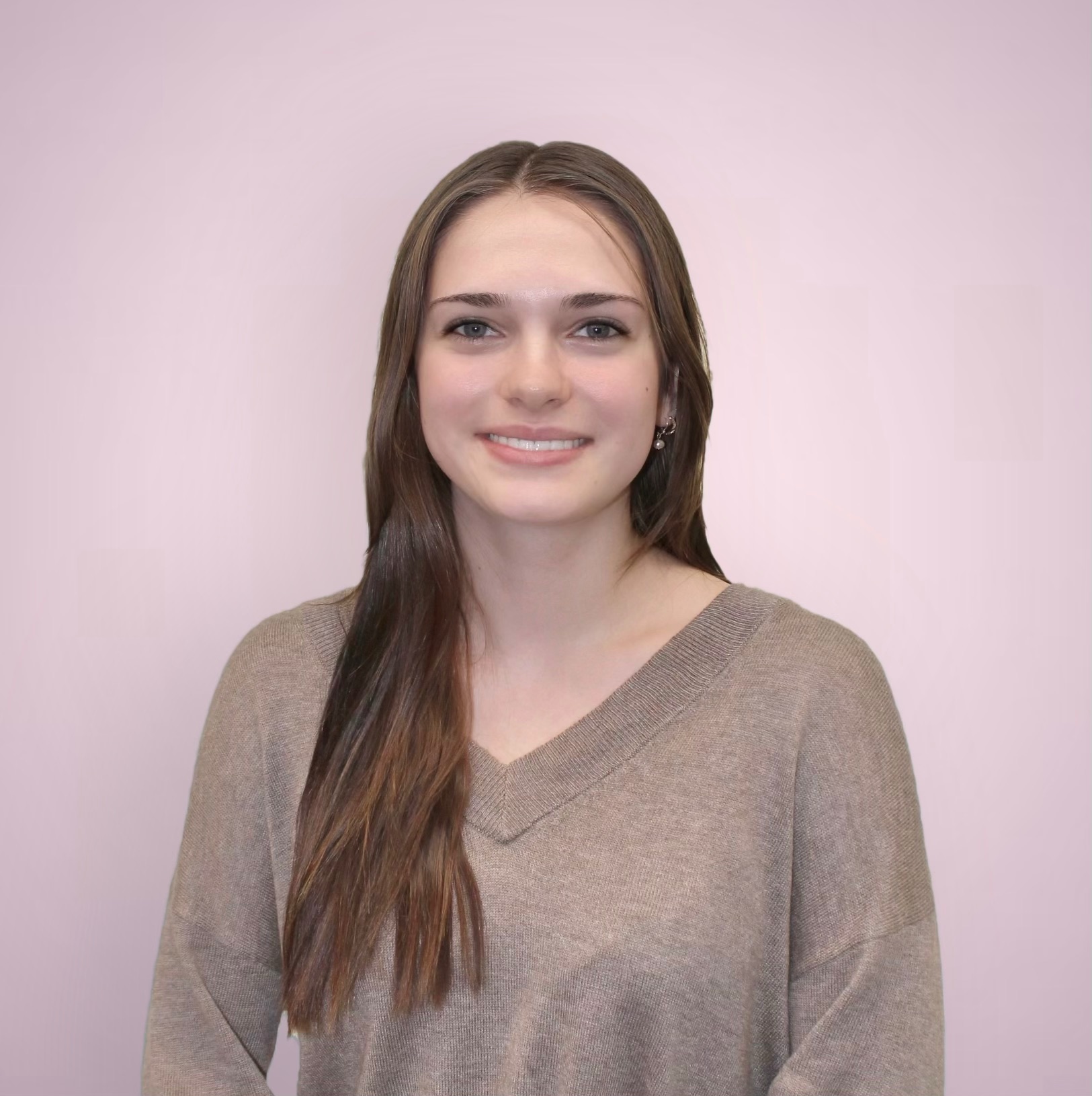 Headshot picture of the graphic designer Susan Wheelock with a pink background